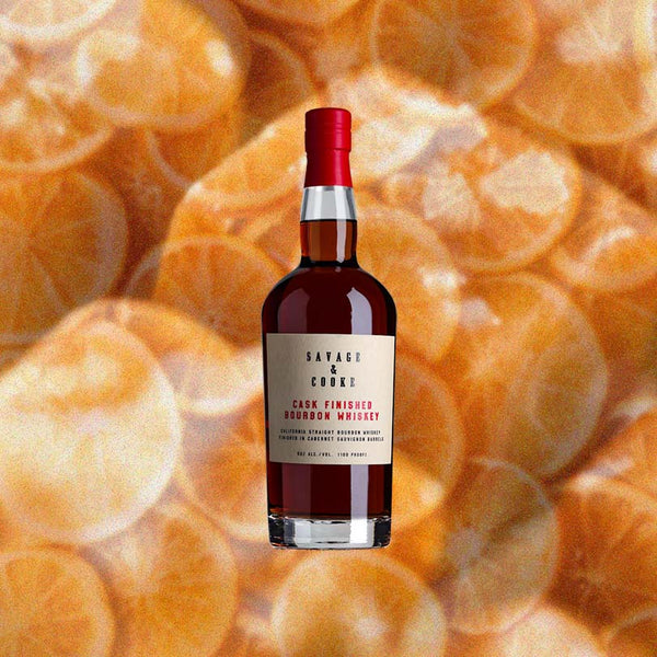 Bottle of Savage & Cooke Cask Finished Bourbon over backdrop image of sliced oranges.