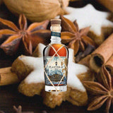 Bottle of Planteray Sealander Rum over backdrop image of spices and a cookie.