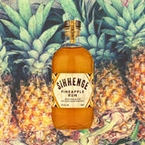 Bottle of Sihhenge Pineapple Rum with pineapples in the background