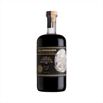 A dark rich liquid in a beautiful, apothecary shaped bottle. The label reads NOLA Coffee Liqueur. There's a sepia toned illustration of an old style Spanish buildings in an oval emblem on the bottle.