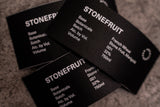 Close-up of Empirical Stonefruit labels on a textured surface