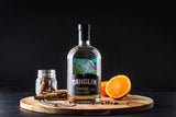 Bottle of Tanglin Orchid Gin on a wooden board with an orange and spices against a dark background