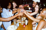 Group of people toasting with glasses at a party