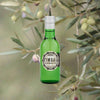 A shorter bottle - 500ml -in simple green. A plain label that reads: Catalan Aperitif. TIMBAL Vermouth Extra Dry on the front. All set against a lovely backdrop of orange and light purple olives growing on trees, evoking the briny flavor found in the vermouth.