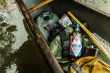 Westland whiskey bottle in a canoe with camping gear