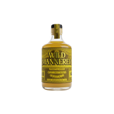 A bottle of Wild Mannered Pineapple Ginger All-Made Cocktail mix, featuring a yellow and black label with the brand name 'WILD MANNERED' in bold black letters, filled with a golden-yellow liquid, set against a plain white background.