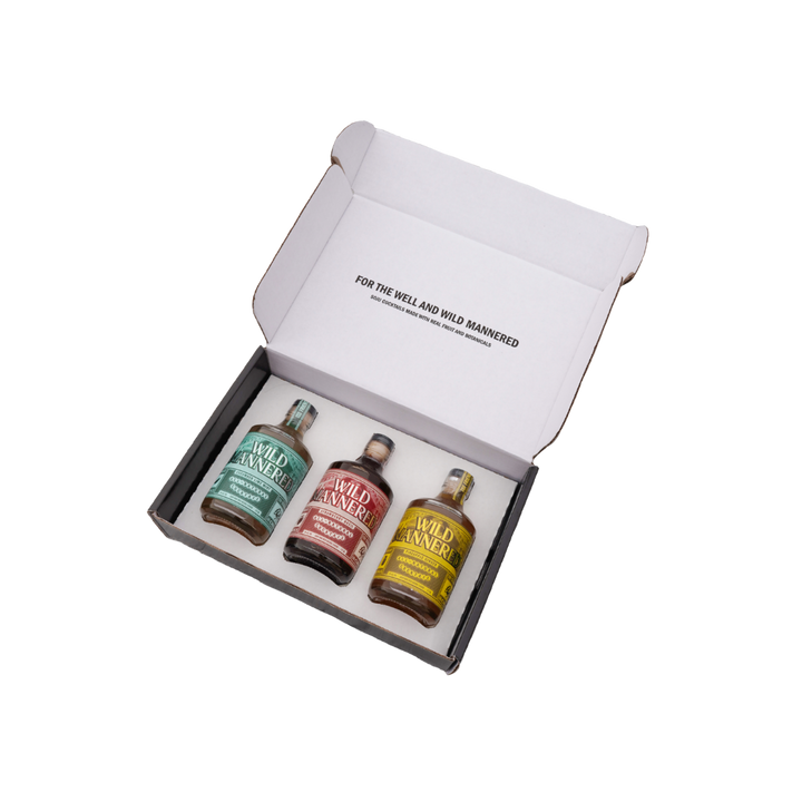 Three bottles of Wild Animal whiskey in a gift box on a white background