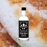 A bottle of Won Soju against a backdrop of carmelized rice cakes.