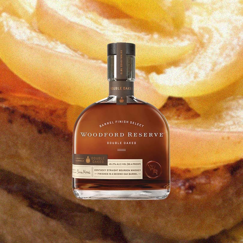 Bottle of Woodford Reserve Double Oaked Bourbon over backdrop image of pudding.
