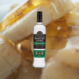 Bottle of Worthy Park Overproof Jamaica Rum over back drop image of Bananas.