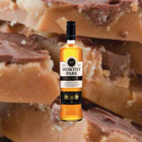 Bottle of Worthy Park Select Jamaica Rum over backdrop image of fudge up close.