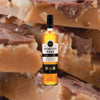Bottle of Worthy Park Select Jamaica Rum over backdrop image of fudge up close.