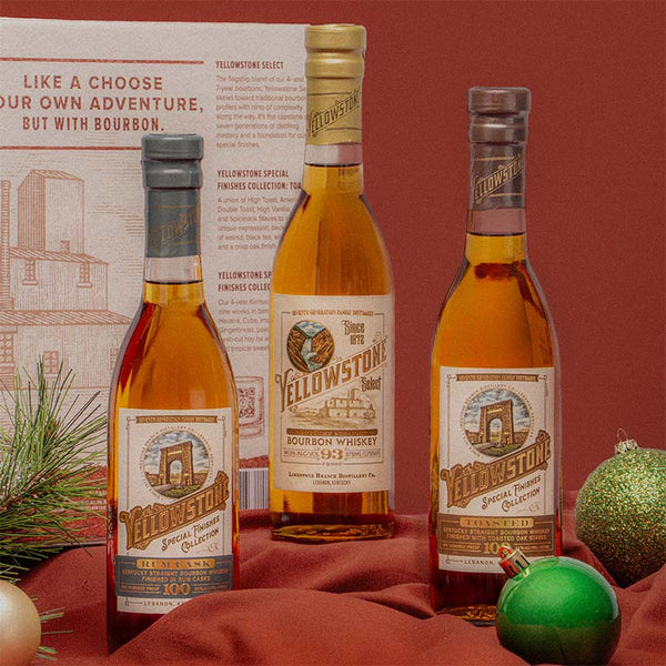 Yellowstone Bourbon 375ml Giftpack on a red tablecloth next to Christmas ornaments. 