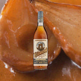 Bottle of Yellowstone Special Finishes Collection: Rum Cask over backdrop image of fruit.