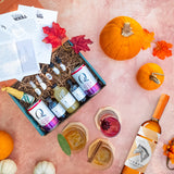 Overhead photo of fall themed tablescape with a bottle of Pinhook Kentucky Straight Bourbon Whiskey and a Shaker and Spoon cocktail kit.
