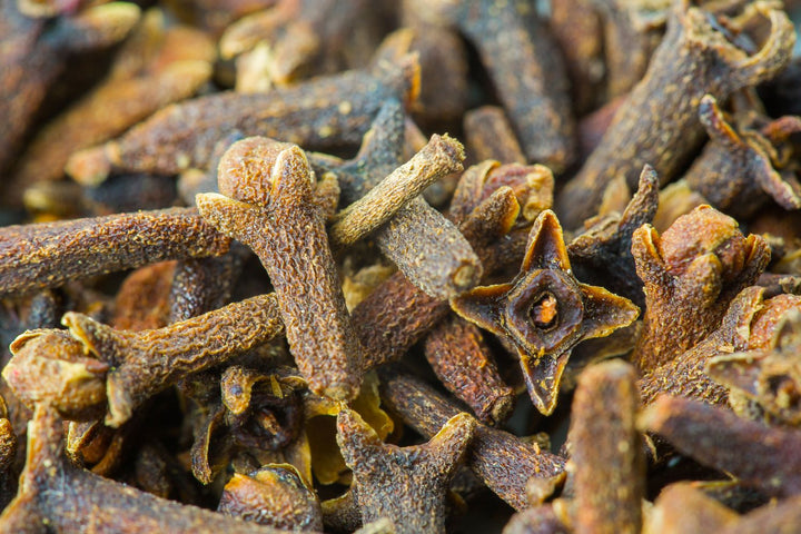 Close-up of dried cloves with a warm brown color.
