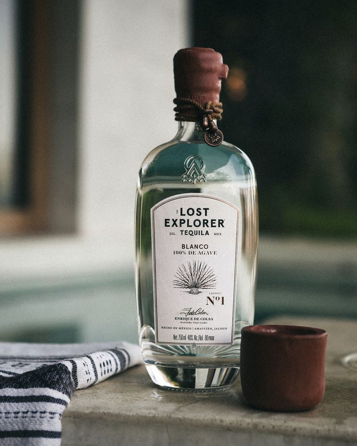 Lost Explorer Tequila bottle with a small cup on a surface
