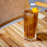 Glass of iced tea with a lemon twist on a wooden table