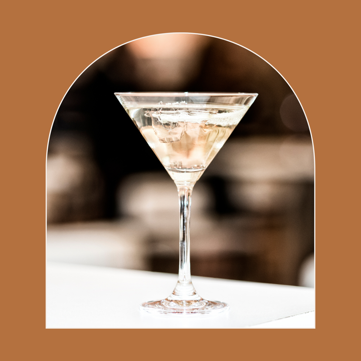 Cocktail in a martini glass with a blurred background