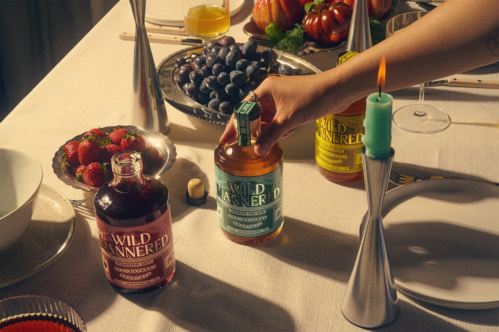 Table setting with Wild Panthered bottles and a lit candle.