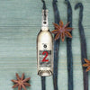 Bottle of 123 Organic Tequila Reposado (Dos). Backdrop of stars and light blue wallpaper.