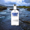 Bottle of Absolut Vodka over backdrop of a river on a cloudy day.