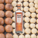 Bottle of Absolut Elyx Vodka over backdrop of baked goods.