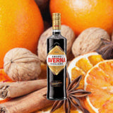 Bottle of Amaro Averna over backdrop of oranges and spices.
