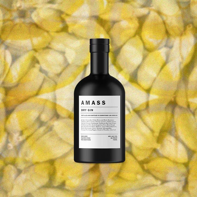 Bottle of Amass Dry Gin over backdrop image of bananas. 