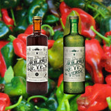 Bottles of Ancho Reyes Original + Ancho Reyes Verde over a blurred background of colorful red and green chilis