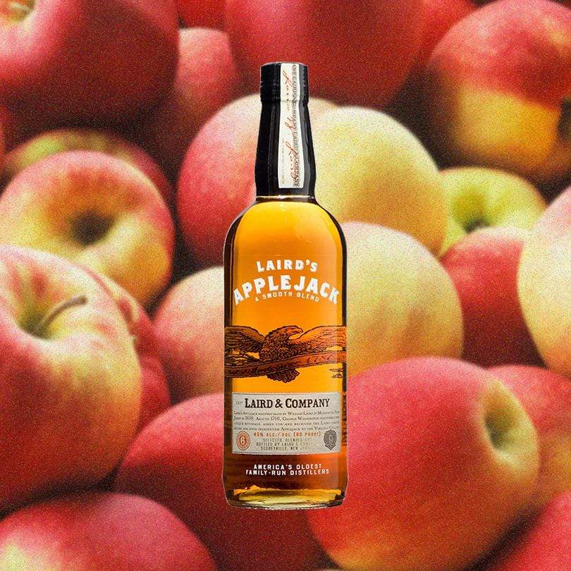 Bottle of Laird's Applejack over backdrop of apples