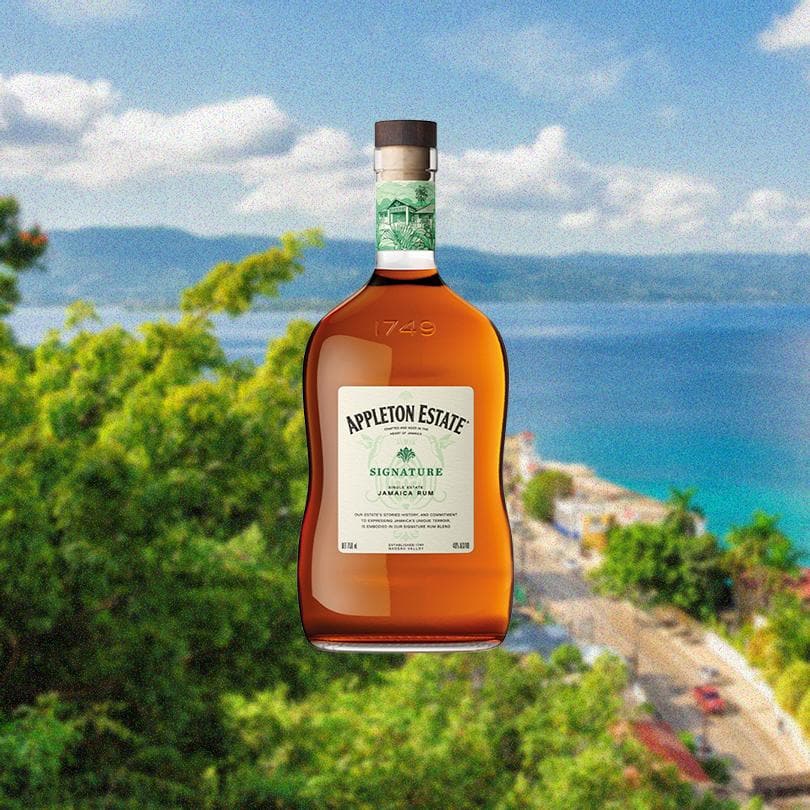 Bottle of Appleton Estate Signature Jamaican Rum 5 Years Old. Backdrop of the ocean.