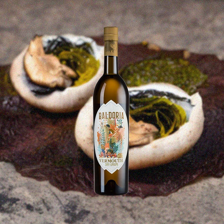 Bottle of Baldoria Dry Umami Vermouth over background image of unidentifiable objects.