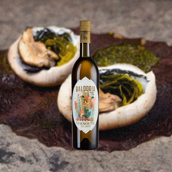 Bottle of Baldoria Dry Umami Vermouth over background image of unidentifiable objects.
