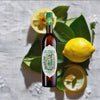 Bottle of Baldoria Verdant Vermouth over background image of lemon and green leaves.