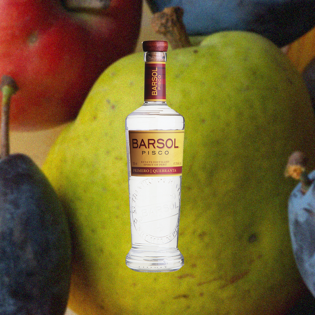 Bottle of Bottle of Barsol Primero Quebranta Pisco over backdrop of a pear.