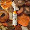 750ml bottle of Basil Hayden Kentucky Straight Bourbon Whiskey over backdrop of dried fruit.