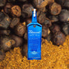 750ml bottle of Bluecoat American Dry Gin over backdrop of chestnuts.