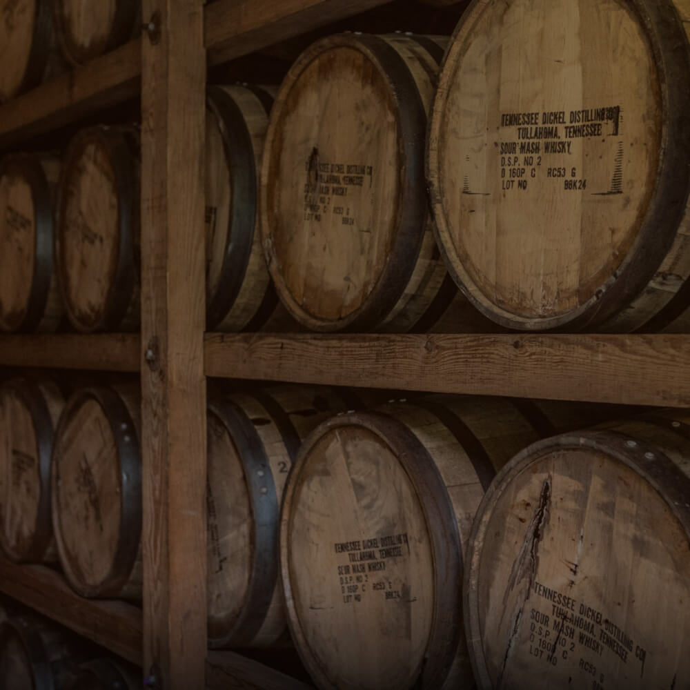 Barrels of whiskey on racks in a distillery.