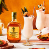Bottle of Buchanan's Pineapple on a table next to two daiquiri cocktails..