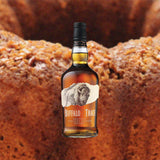Image of Buffalo Trace Kentucky Straight Bourbon Whiskey bottle with a bundt cake behind it