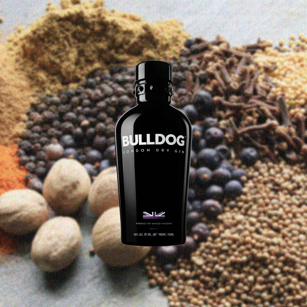 Bottle of Bulldog London Dry Gin over backdrop of blueberries, walnuts, and assorted grains.