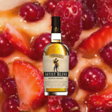 Bottle of Compass Box Great King Street Artist's Blend Scotch over blurred background of red berries.