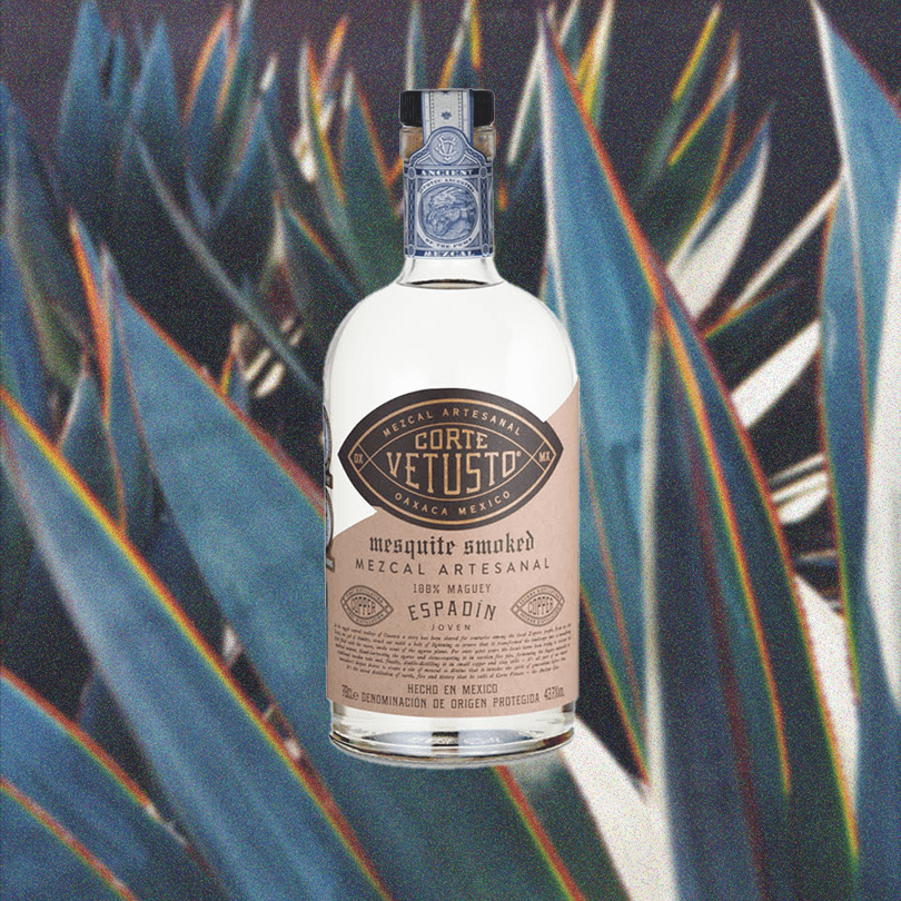 Bottle of Corte Vetusto Espadin Mezcal over backdrop of blue agave animated or edited image.