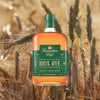 Bottle of Canadian Club Rye Whisky over backdrop of blurred grains.