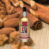 Bottle of Cazadores Añejo Tequila over blurred background of nuts and cinnamon sticks.