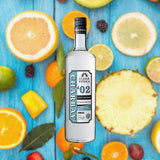 1 Liter bottle of Charbay Clear Vodka over backdrop of fruit pieces.