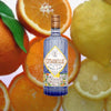 Bottle of Citadelle Jardin d'Été over backdrop of oranges and lemons.