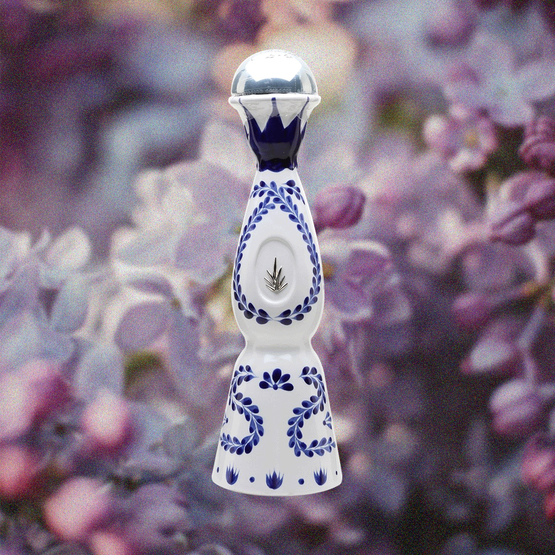 Clase Azul Reposado Tequila in a handmade bottle over a purple flower background.