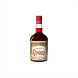 Bottle of Tempus Fugit Creme de Noyaux. A bottle with a bright red cap.